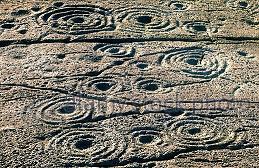 Carved stone with circles and spirals match Hawaii's lava ringed holes.